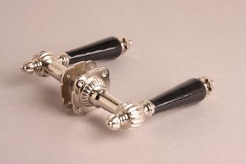 Deurklink blinkend nikkel met ribbel, zwart porselein en rozetten